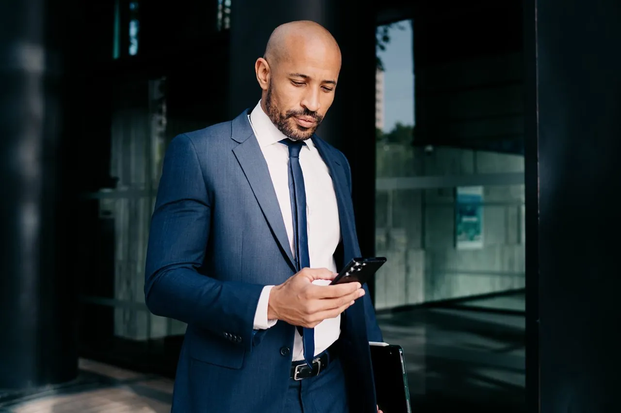 RealNex mobile app on smartphone showing commercial real estate CRM contacts and property records