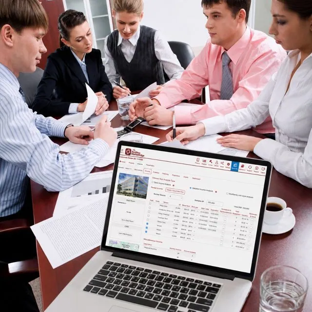 Commercial real estate team reviewing MarketEdge rent roll projections on a laptop