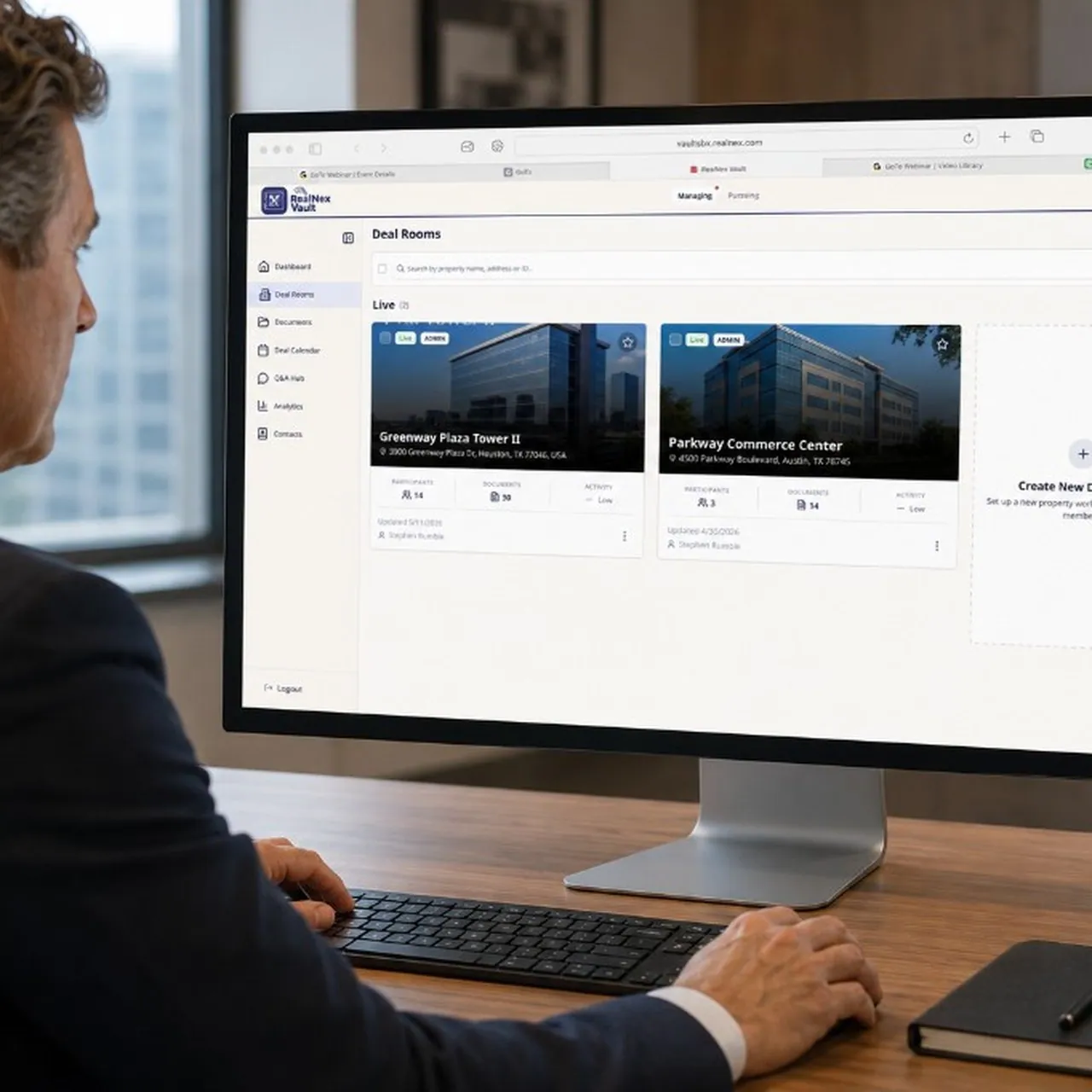 Broker reviewing integrated workflow on monitor