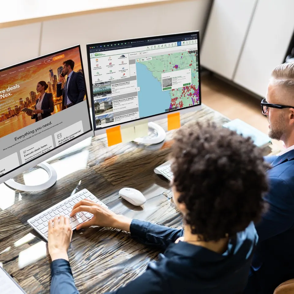 Professional working across multiple monitors in an integrated Navigator workflow