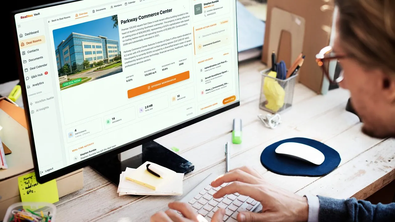 Professional reviewing Parkway Commerce Center deal details in RealNex Vault on a desktop monitor